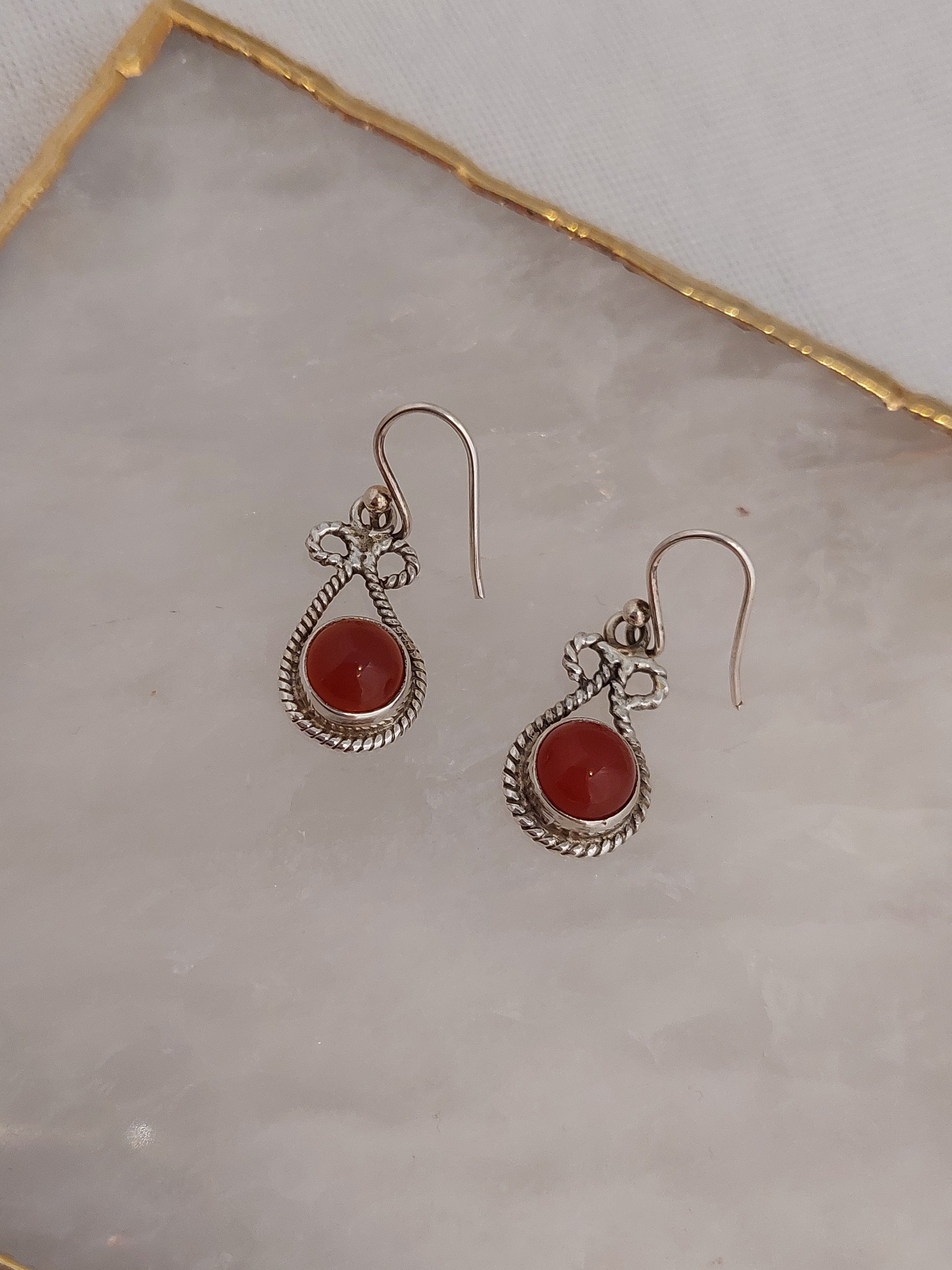 Round Carnelian stone set in Sterling Silver fancy rope style setting in teardrop shape