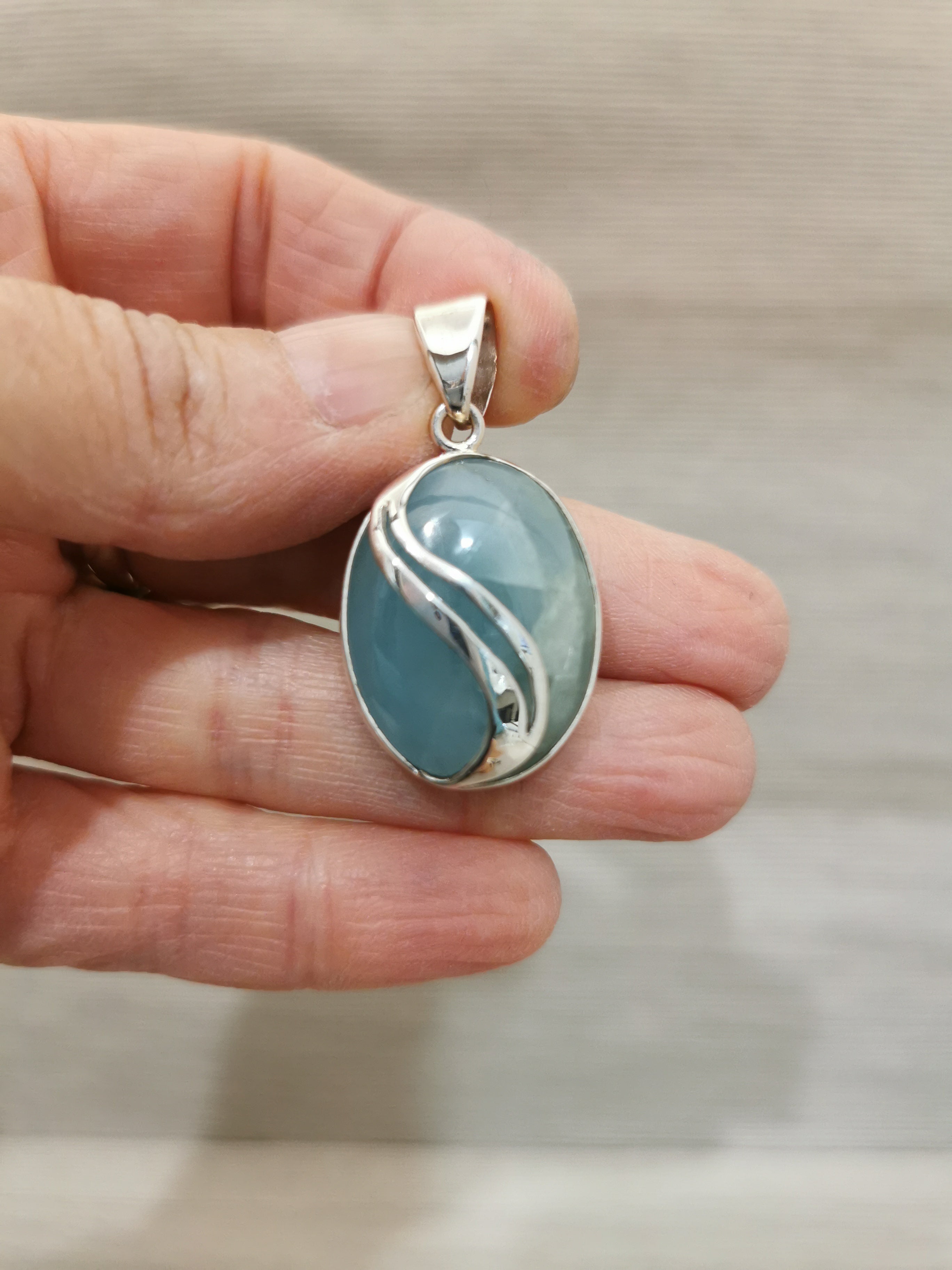 Aquamarine Oval Pendant - 925 Sterling Silver with Decorative Wave Pattern